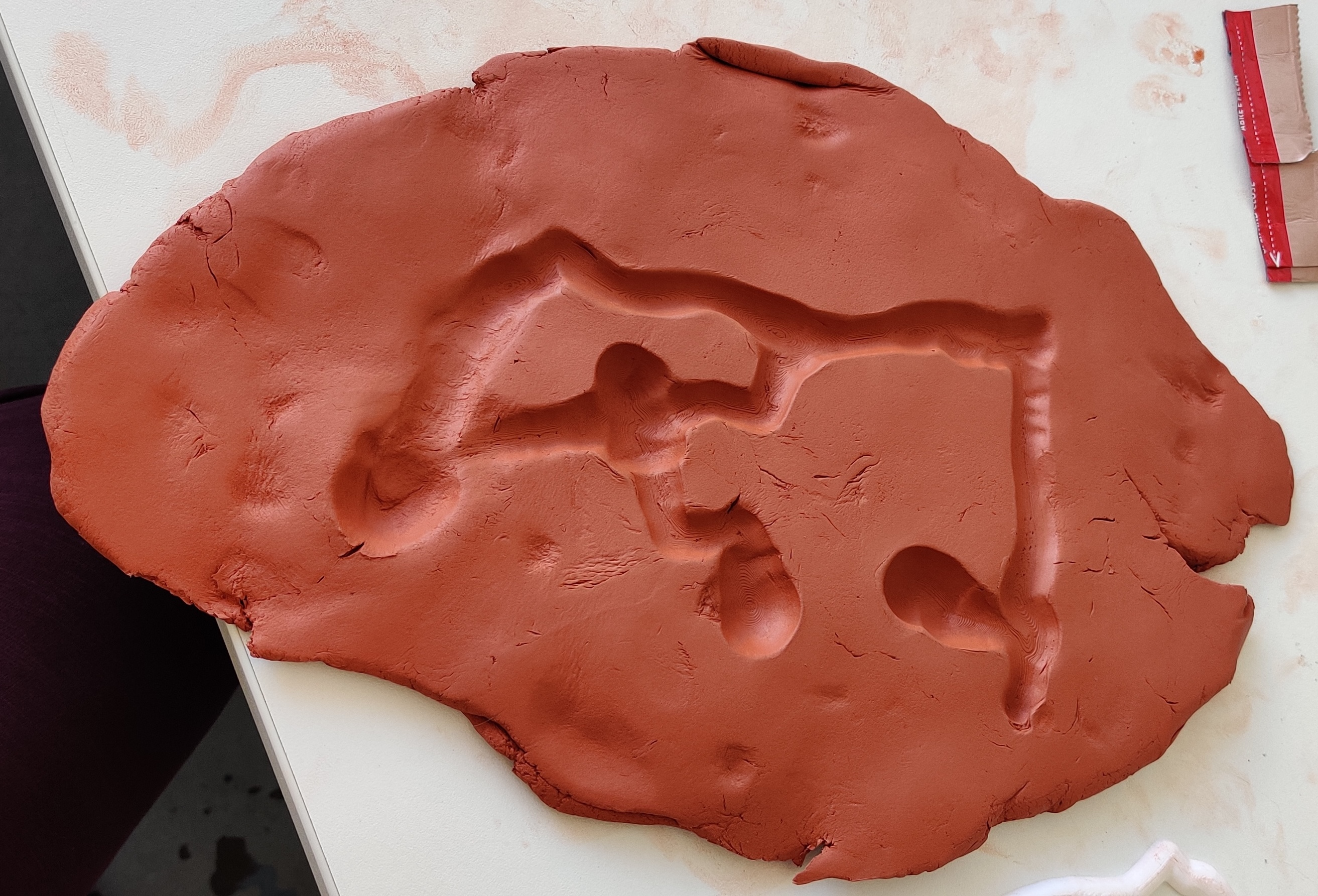 Pressing it down into clay